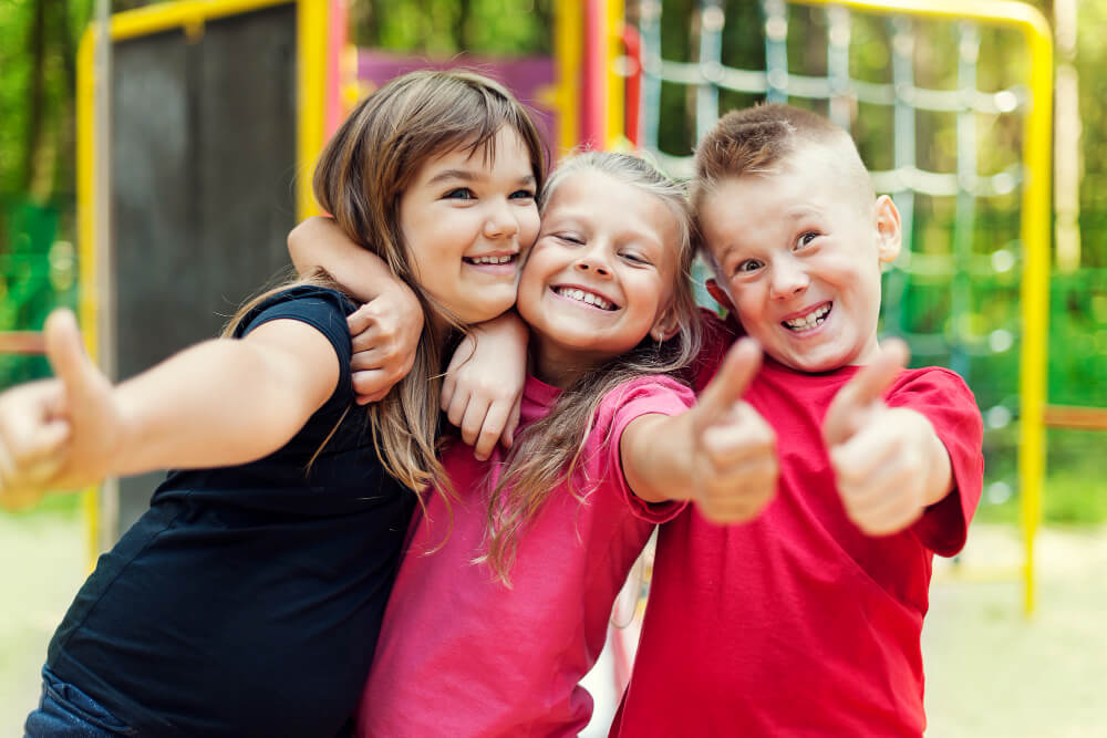 happy-children-showing-ok-sign-playground-1