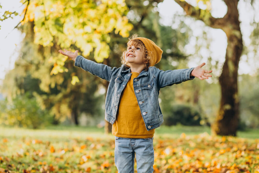 cute-boy-playing-with-leaves-autumn-park-1